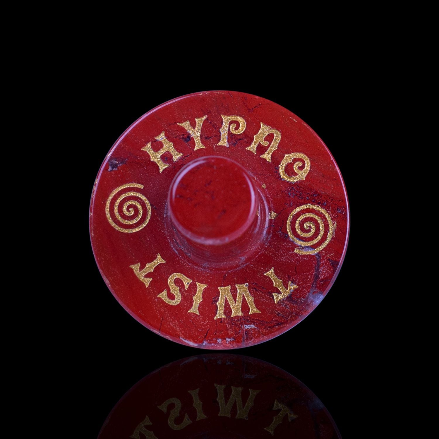 Front View Of The Naturally Wicked Exclusive Hypnotwister. A Red Jasper Crystal Spinning Top Engraved With Hypno Twist